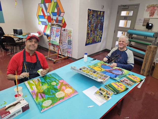 Two men painting in an art studio