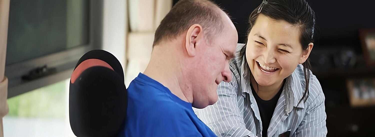 Careers Join our team of essential employees. Smiling woman interacts with man.