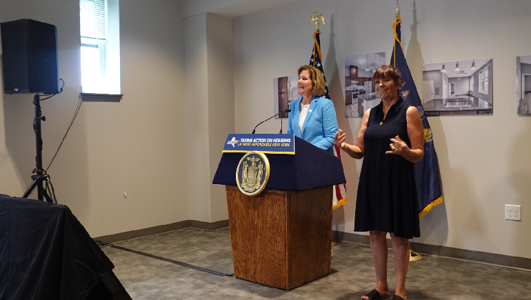 Karen Gambino (right) provides ASL interpretation for Anne McCaffrey, People Inc. CEO during a press conference.