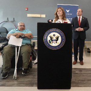 Lynette Trudeau, Rehabilitative Health Services patient and U.S. Congressman Timothy Kennedy look on as Kayla Conaway, People Inc. Physical Therapist addresses the audience.